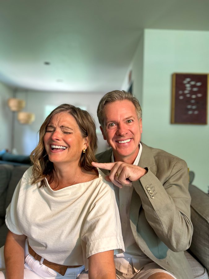 Julia laughing while Eric points at her