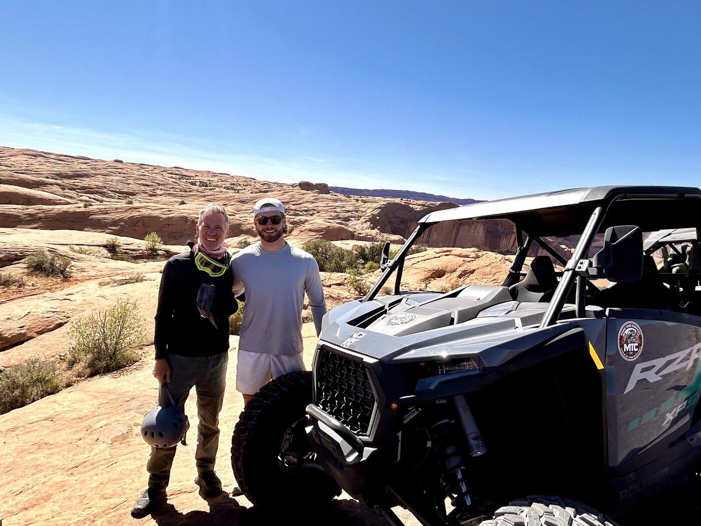 Eric and Connor riding side-by-sides through the desert.
